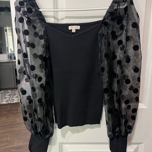 Elegant Black Top with Sheer Polka Dot Sleeves